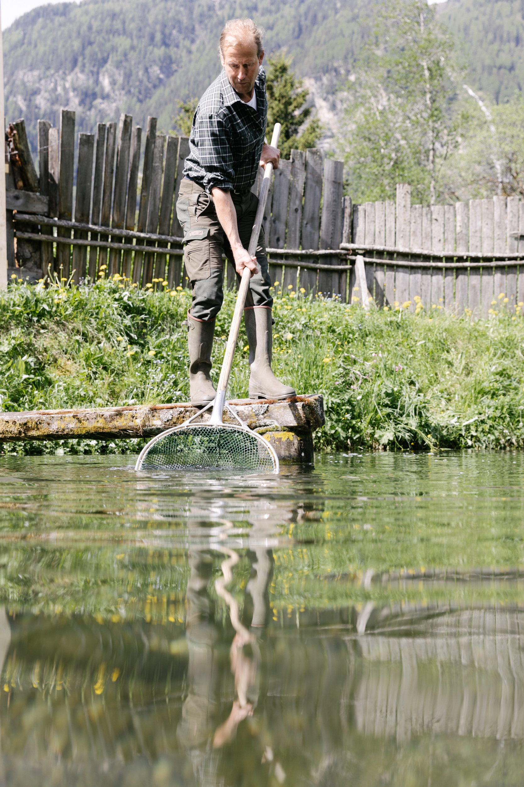 Fischproduzent Raimund Mrak bei seinem Fischteich in Längenfeld